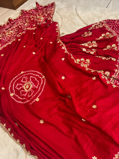 Beautiful Blood Red Gajji Silk Bandini Lehenga Set with Beautiful Gota Handwork all over the Lehenga and Dupatta. Comes with a beautiful Gajji silk blouse piece with gota work