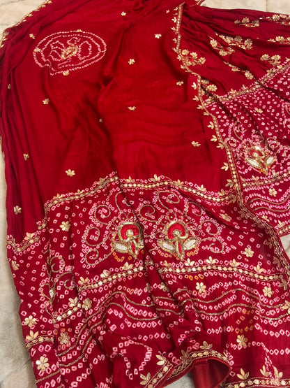 Beautiful Blood Red Gajji Silk Bandini Lehenga Set with Beautiful Gota Handwork all over the Lehenga and Dupatta. Comes with a beautiful Gajji silk blouse piece with gota work