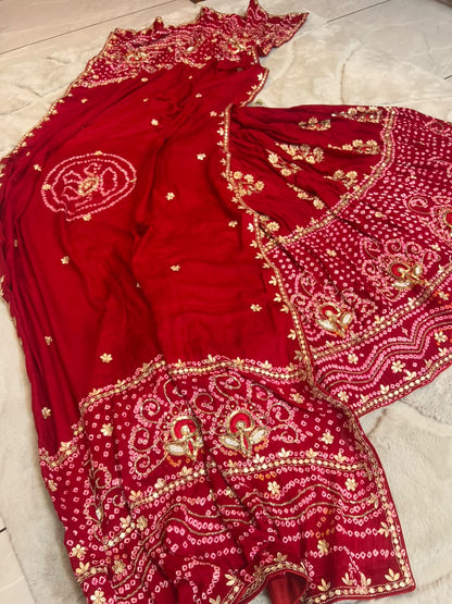 Beautiful Blood Red Gajji Silk Bandini Lehenga Set with Beautiful Gota Handwork all over the Lehenga and Dupatta. Comes with a beautiful Gajji silk blouse piece with gota work