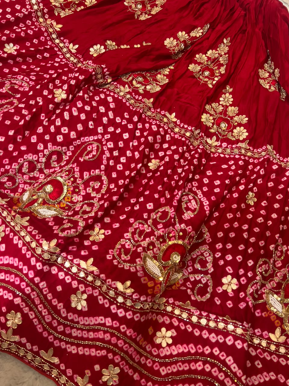 Beautiful Blood Red Gajji Silk Bandini Lehenga Set with Beautiful Gota Handwork all over the Lehenga and Dupatta. Comes with a beautiful Gajji silk blouse piece with gota work