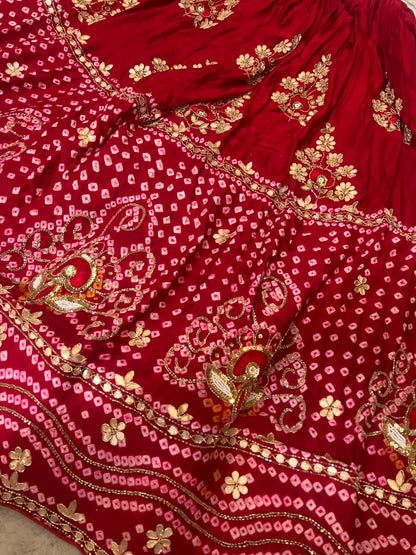 Beautiful Blood Red Gajji Silk Bandini Lehenga Set with Beautiful Gota Handwork all over the Lehenga and Dupatta. Comes with a beautiful Gajji silk blouse piece with gota work