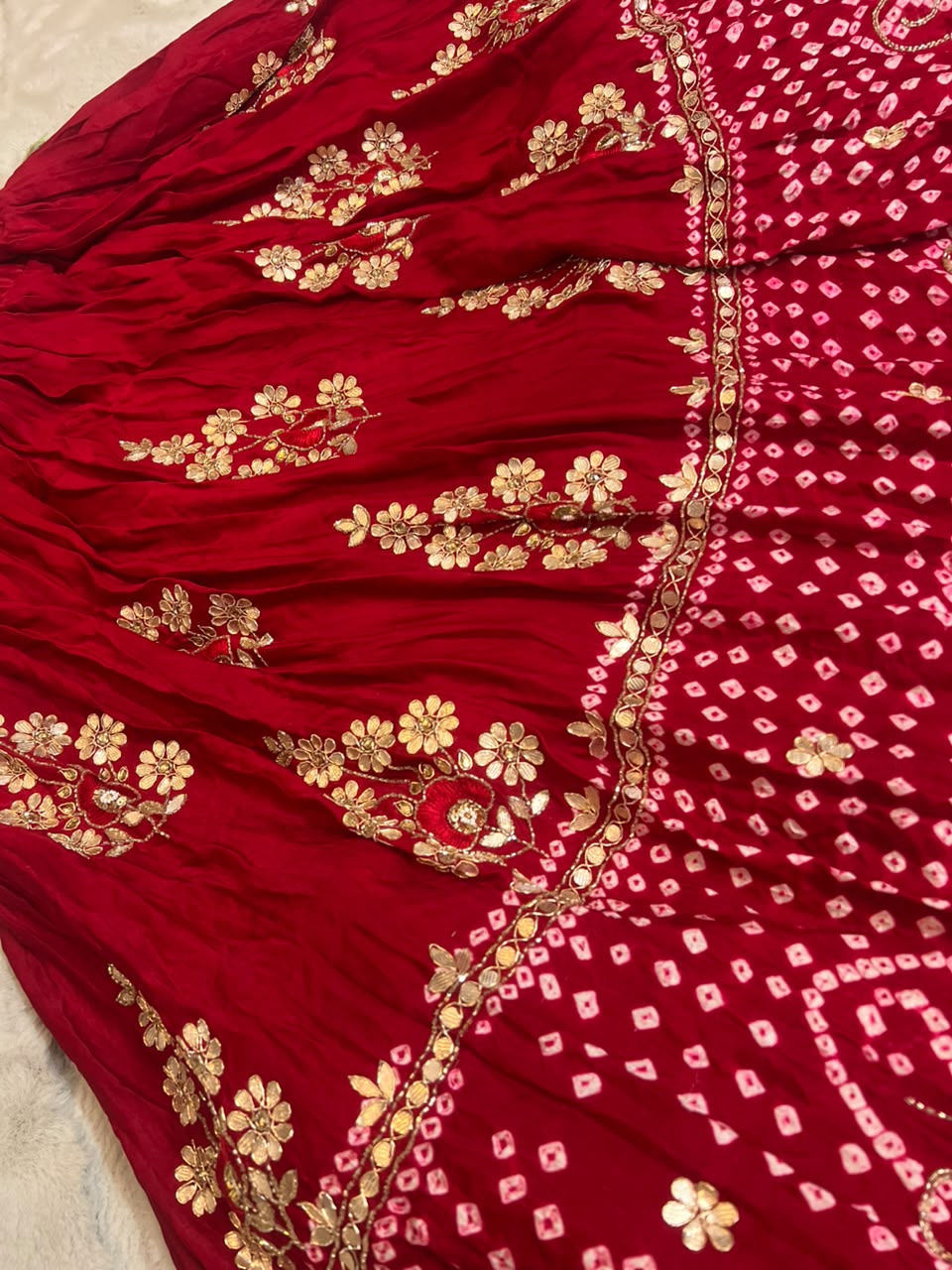 Beautiful Blood Red Gajji Silk Bandini Lehenga Set with Beautiful Gota Handwork all over the Lehenga and Dupatta. Comes with a beautiful Gajji silk blouse piece with gota work
