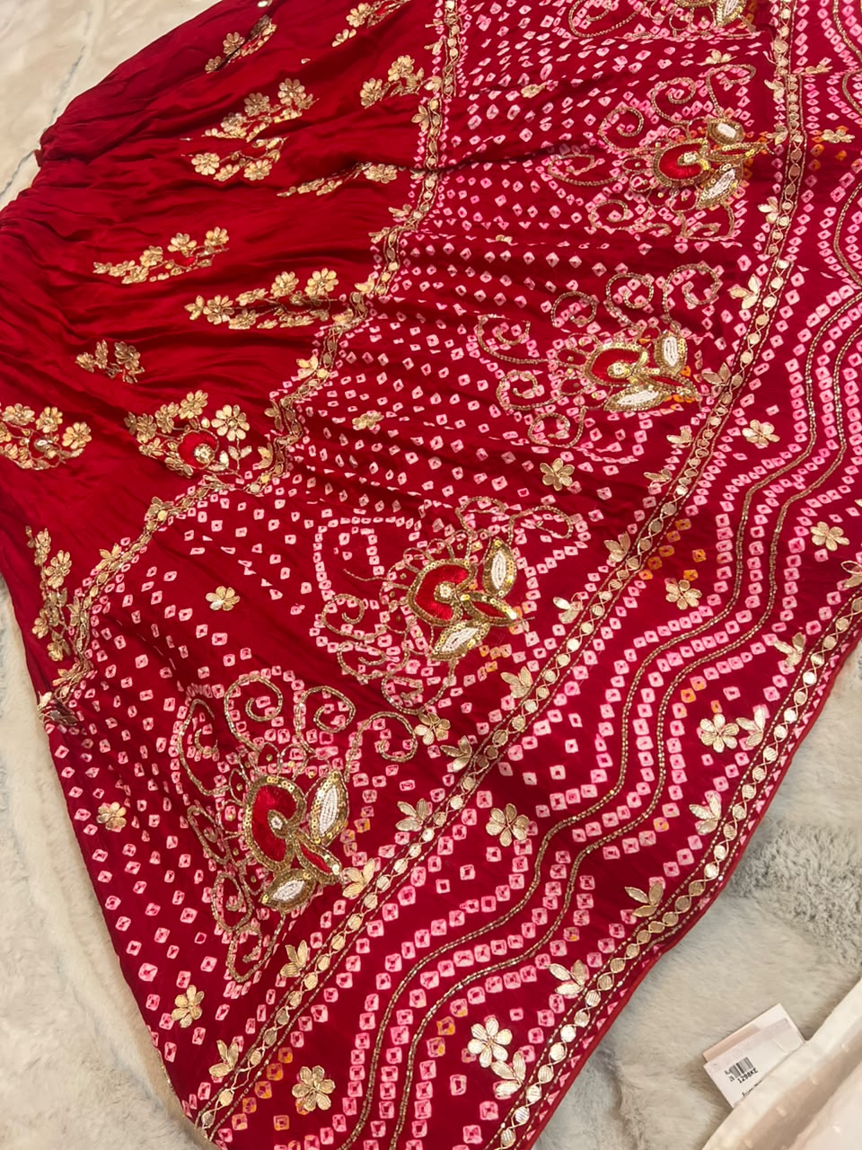 Beautiful Blood Red Gajji Silk Bandini Lehenga Set with Beautiful Gota Handwork all over the Lehenga and Dupatta. Comes with a beautiful Gajji silk blouse piece with gota work