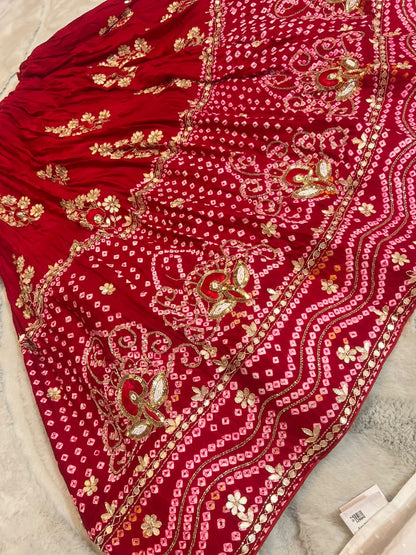Beautiful Blood Red Gajji Silk Bandini Lehenga Set with Beautiful Gota Handwork all over the Lehenga and Dupatta. Comes with a beautiful Gajji silk blouse piece with gota work