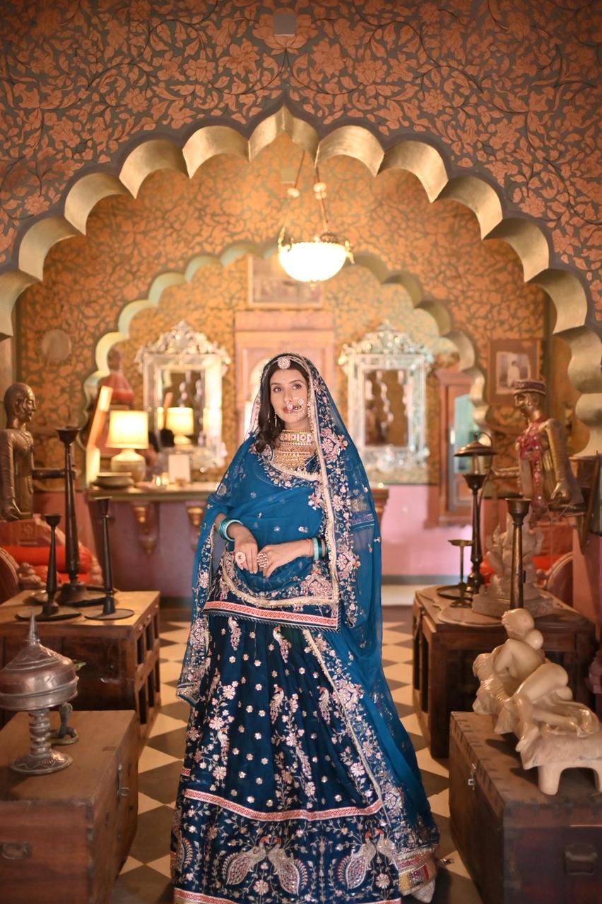 A masterpiece of grace — a peacock-inspired Royal Blue Poshak with a Royal Full Ghera and Pure, Luxurious Fabric. Timeless, Traditional, and Truly Breathtaking. (Stitched)