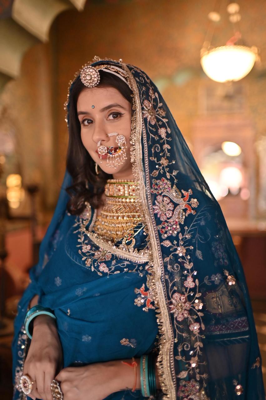 A masterpiece of grace — a peacock-inspired Royal Blue Poshak with a Royal Full Ghera and Pure, Luxurious Fabric. Timeless, Traditional, and Truly Breathtaking. (Stitched)