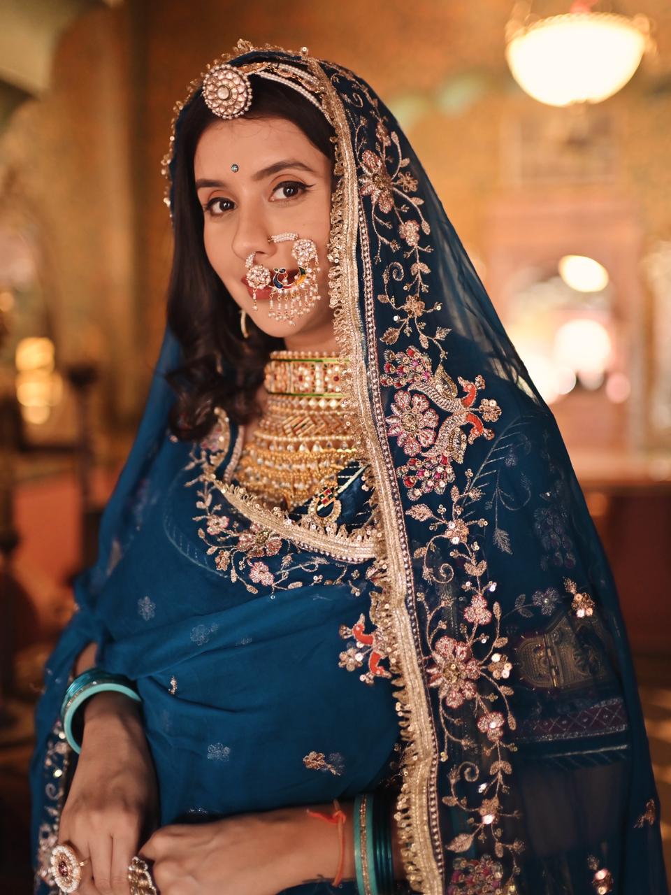 A masterpiece of grace — a peacock-inspired Royal Blue Poshak with a Royal Full Ghera and Pure, Luxurious Fabric. Timeless, Traditional, and Truly Breathtaking. (Stitched)