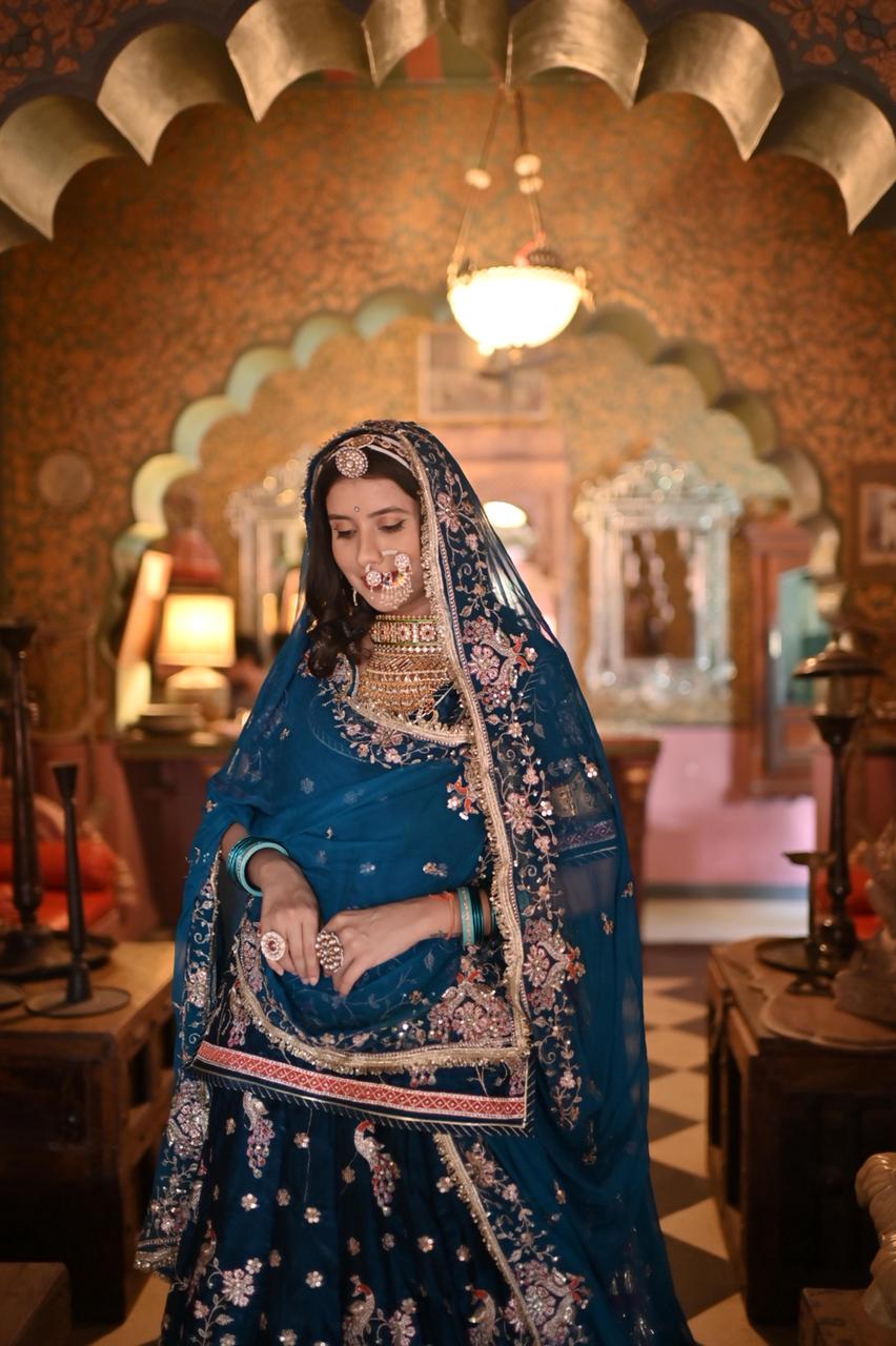 A masterpiece of grace — a peacock-inspired Royal Blue Poshak with a Royal Full Ghera and Pure, Luxurious Fabric. Timeless, Traditional, and Truly Breathtaking. (Stitched)