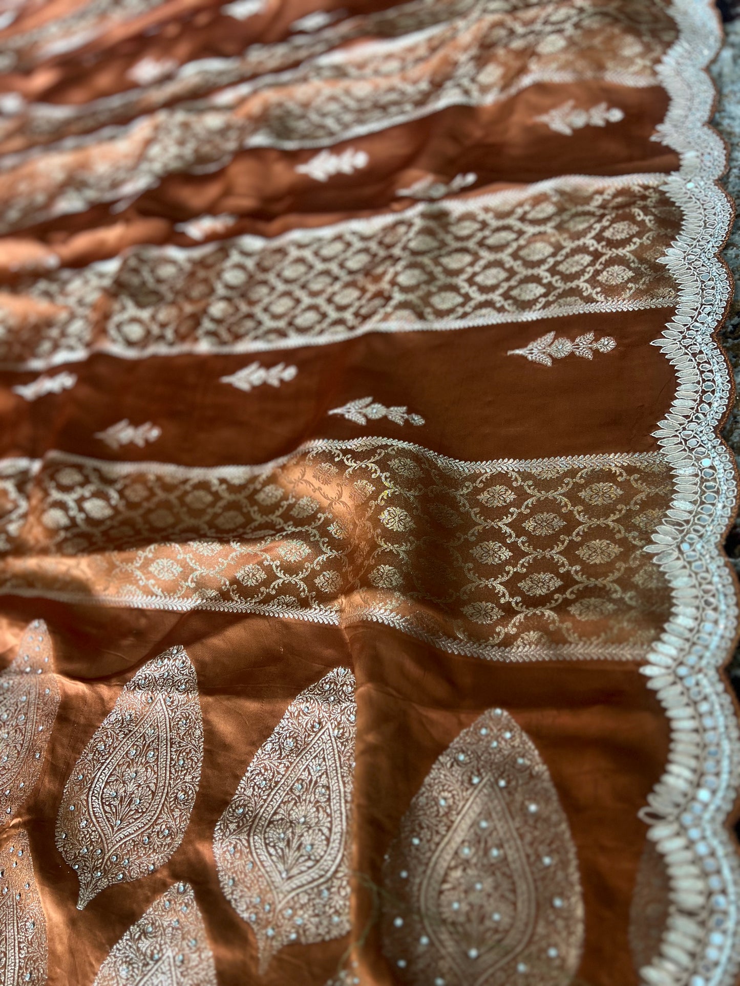 Beautiful Coffee colour Modal Silk Saree with lovely designer zari work on the border and the booties are made up of mirror, Gota and little bit of Zardozi touch.  And the blouse piece makes it look even more beautiful.
