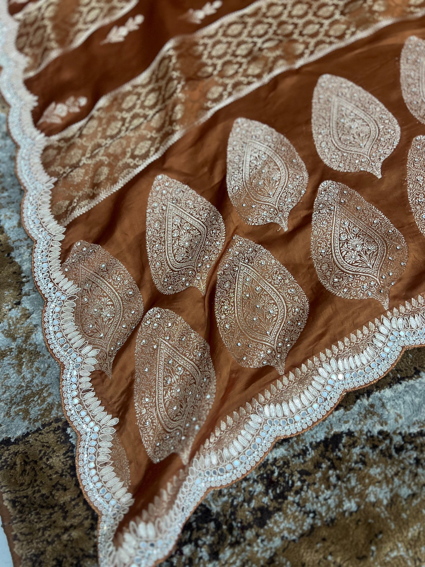 Beautiful Coffee colour Modal Silk Saree with lovely designer zari work on the border and the booties are made up of mirror, Gota and little bit of Zardozi touch.  And the blouse piece makes it look even more beautiful.