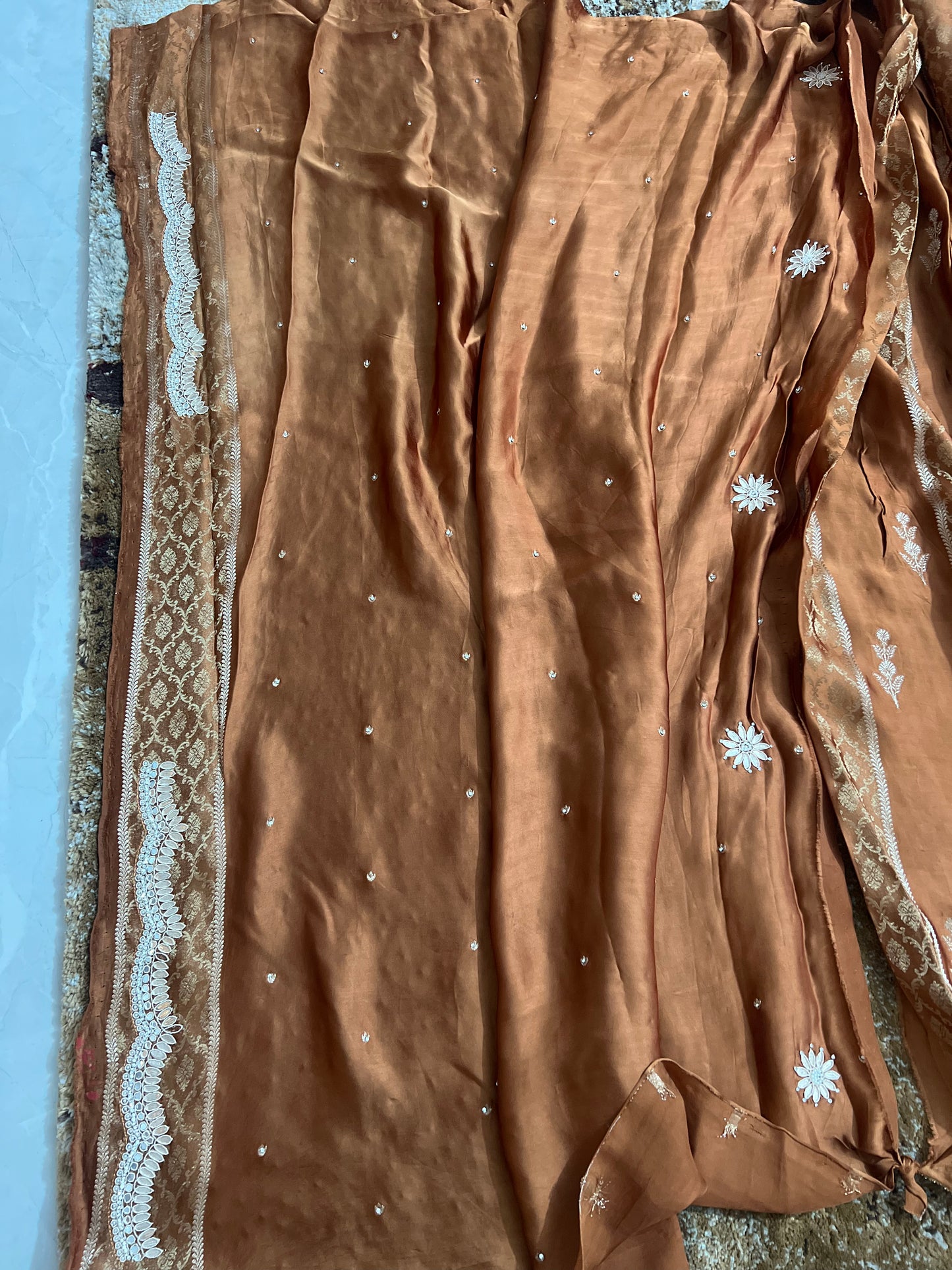 Beautiful Coffee colour Modal Silk Saree with lovely designer zari work on the border and the booties are made up of mirror, Gota and little bit of Zardozi touch.  And the blouse piece makes it look even more beautiful.