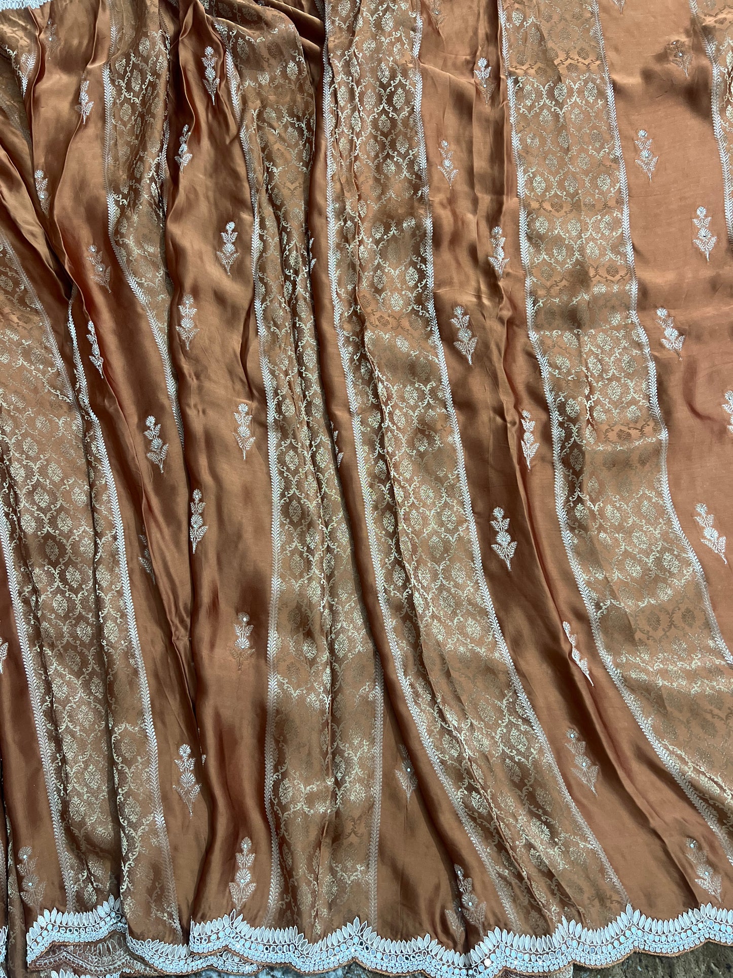 Beautiful Coffee colour Modal Silk Saree with lovely designer zari work on the border and the booties are made up of mirror, Gota and little bit of Zardozi touch.  And the blouse piece makes it look even more beautiful.