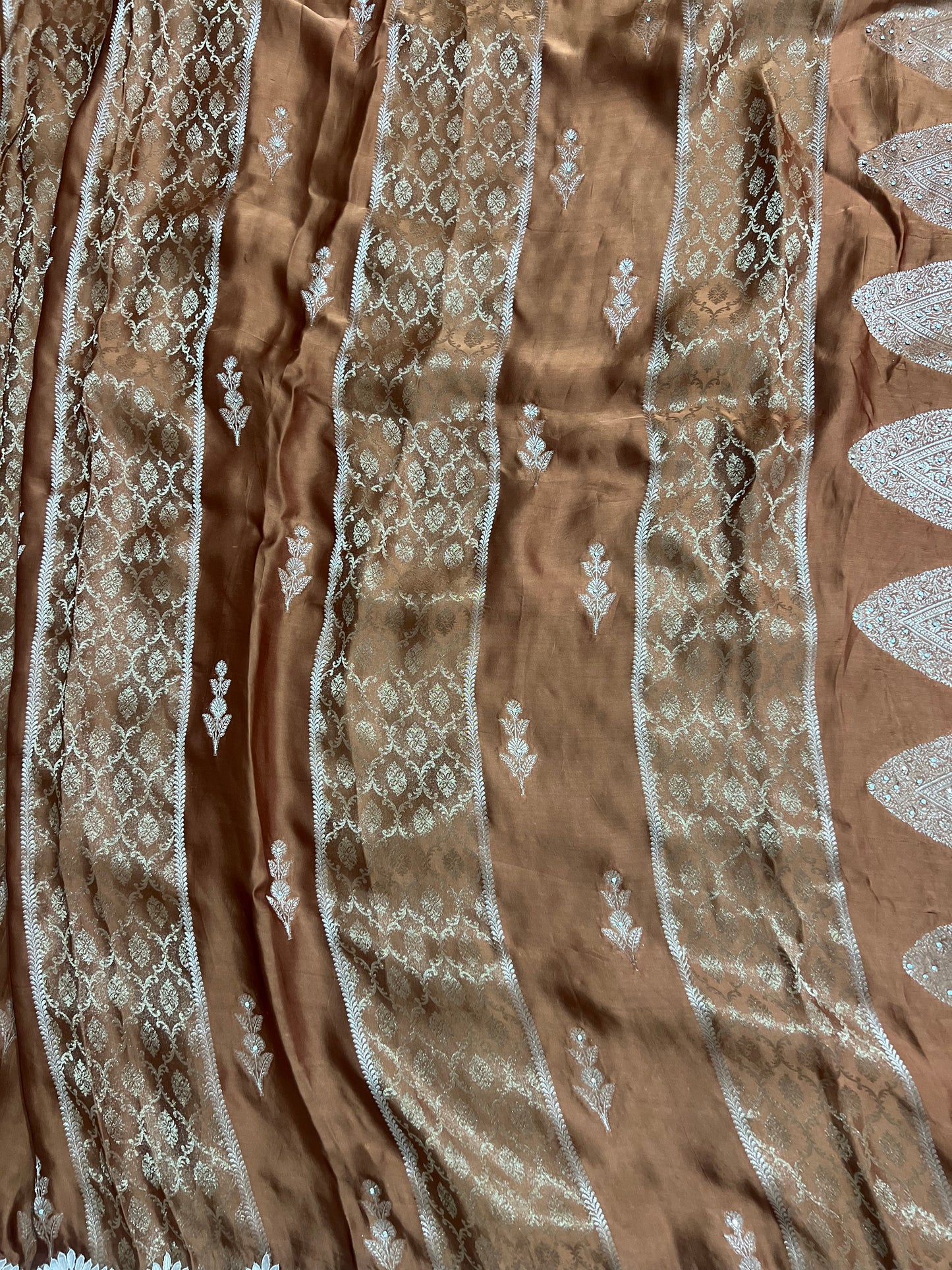 Beautiful Coffee colour Modal Silk Saree with lovely designer zari work on the border and the booties are made up of mirror, Gota and little bit of Zardozi touch.  And the blouse piece makes it look even more beautiful.