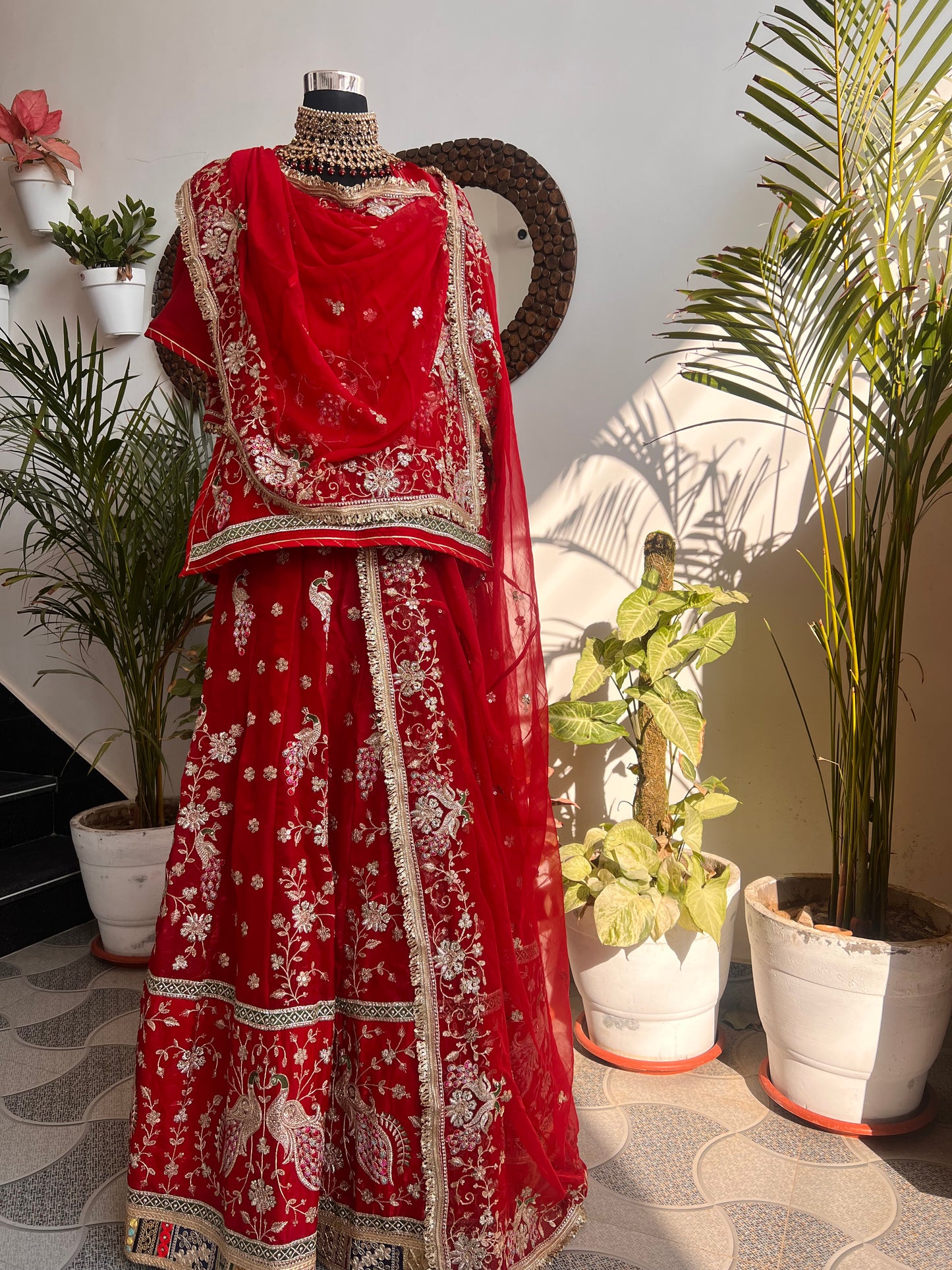 Royalty in every swirl — peacock motifs, full ghera, and the richness of pure fabric. A poshak that tells its own story. (Stitched).