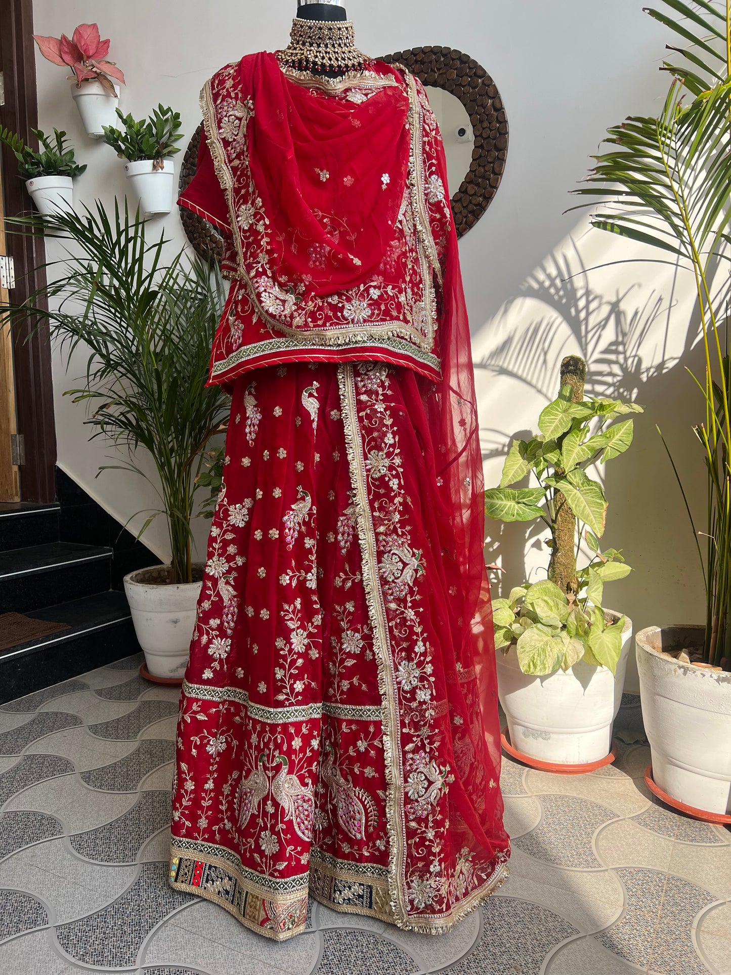 Royalty in every swirl — peacock motifs, full ghera, and the richness of pure fabric. A poshak that tells its own story. (Stitched).