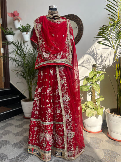 Royalty in every swirl — peacock motifs, full ghera, and the richness of pure fabric. A poshak that tells its own story. (Stitched).
