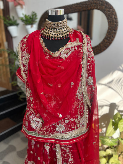 Royalty in every swirl — peacock motifs, full ghera, and the richness of pure fabric. A poshak that tells its own story. (Stitched).