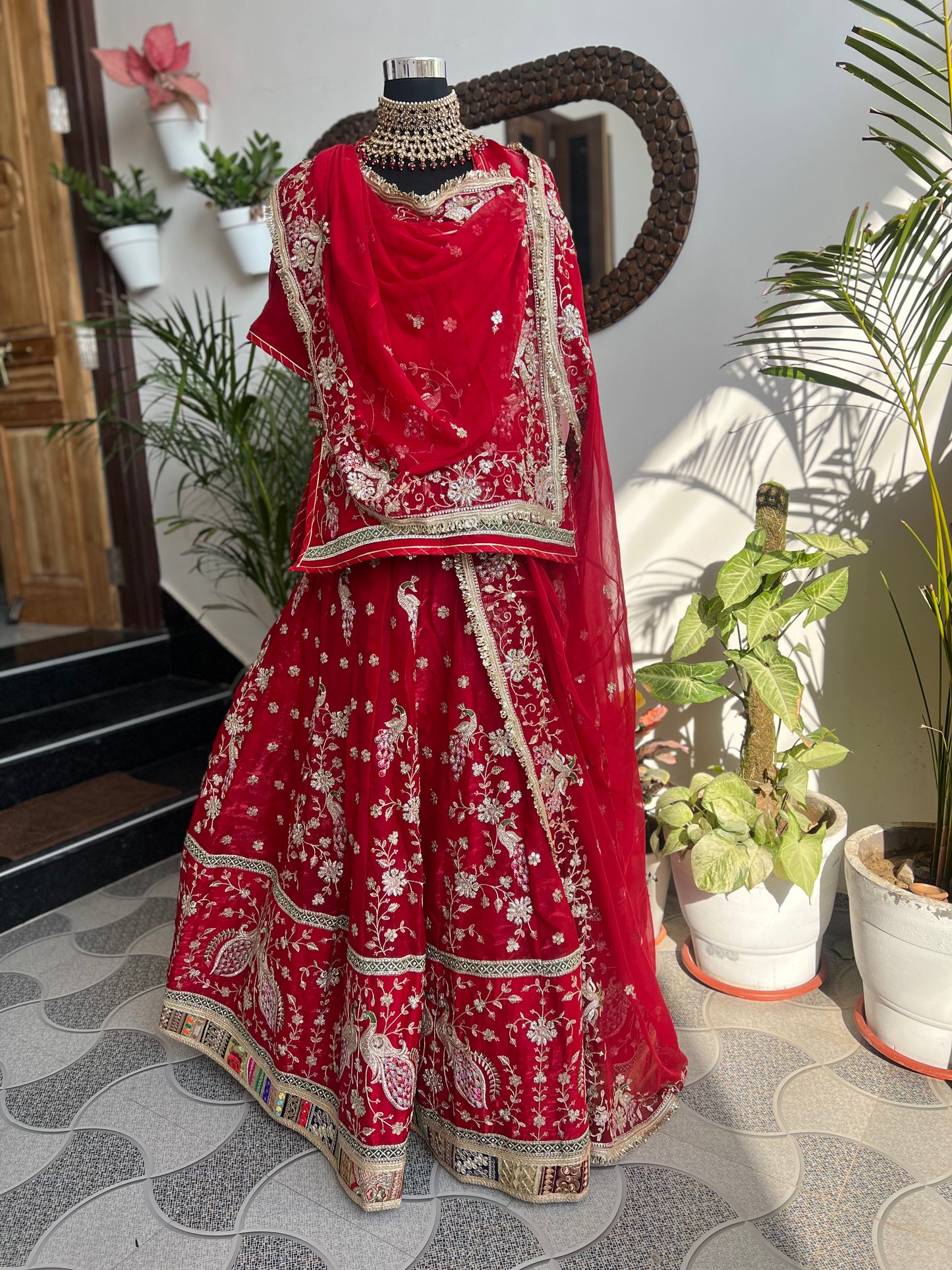 Royalty in every swirl — peacock motifs, full ghera, and the richness of pure fabric. A poshak that tells its own story. (Stitched).