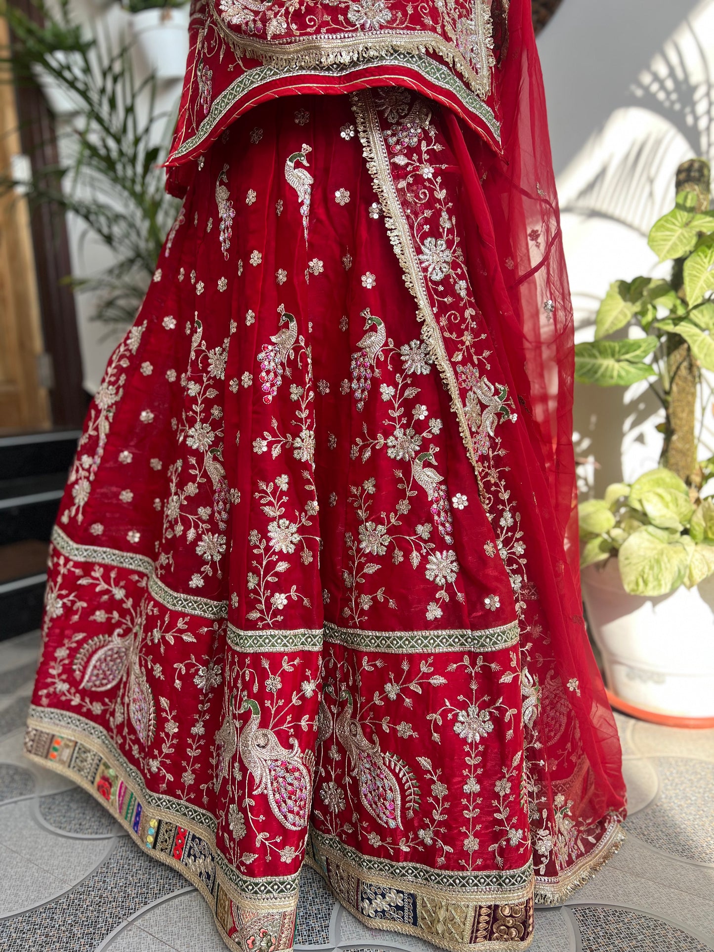 Royalty in every swirl — peacock motifs, full ghera, and the richness of pure fabric. A poshak that tells its own story. (Stitched).