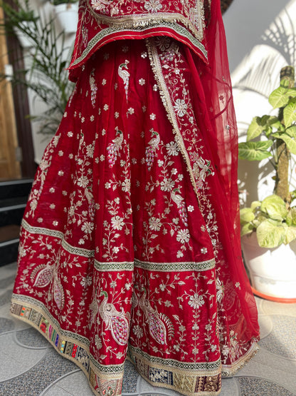 Royalty in every swirl — peacock motifs, full ghera, and the richness of pure fabric. A poshak that tells its own story. (Stitched).