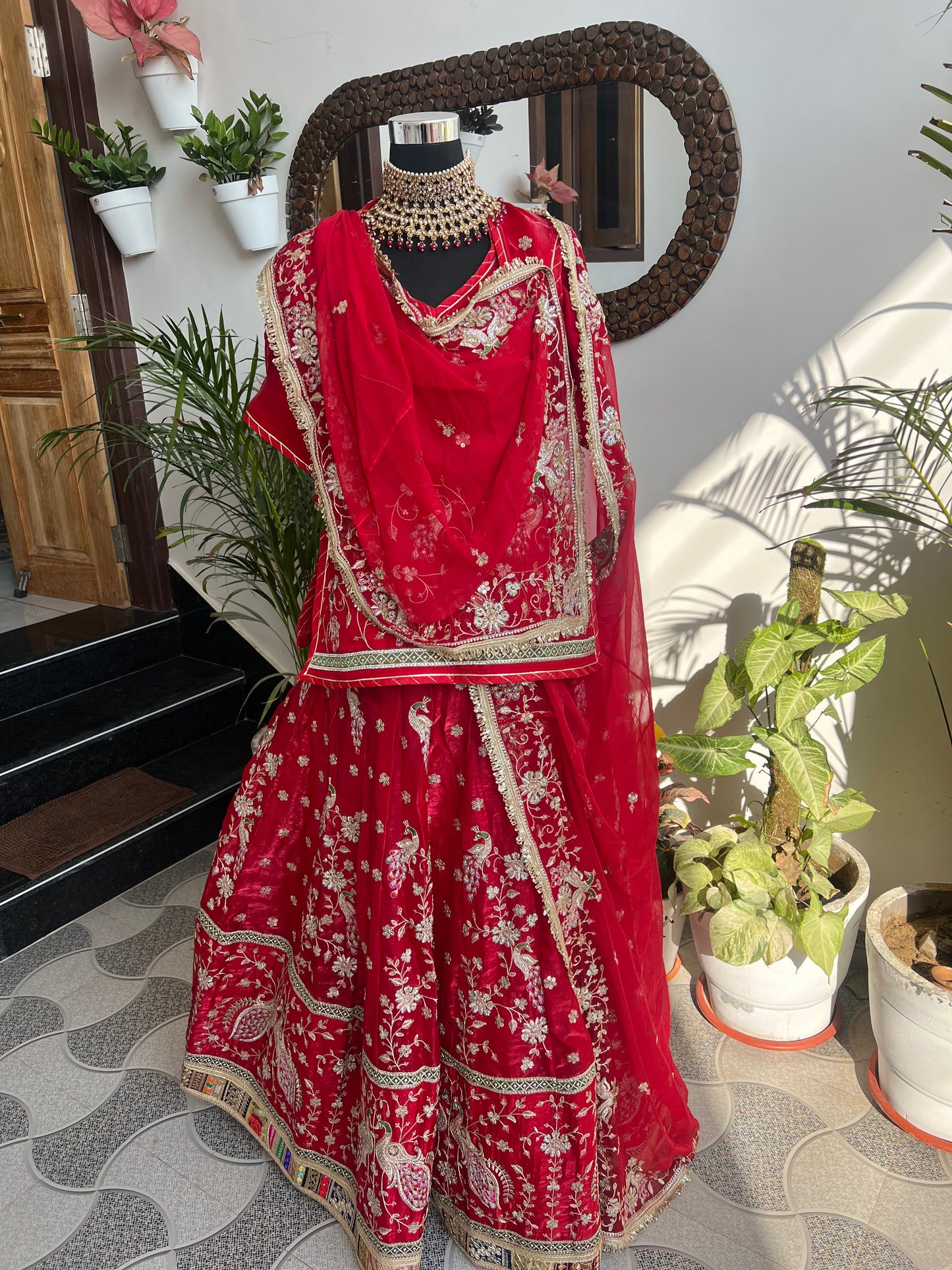 Royalty in every swirl — peacock motifs, full ghera, and the richness of pure fabric. A poshak that tells its own story. (Stitched).