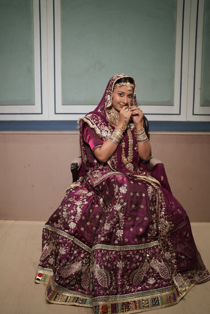 A masterpiece of grace — a peacock-inspired poshak with a royal full ghera and pure, luxurious fabric. Timeless, traditional, and truly breathtaking. (Stitched)
