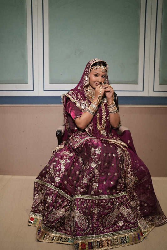 A masterpiece of grace — a peacock-inspired poshak with a royal full ghera and pure, luxurious fabric. Timeless, traditional, and truly breathtaking. (Stitched)