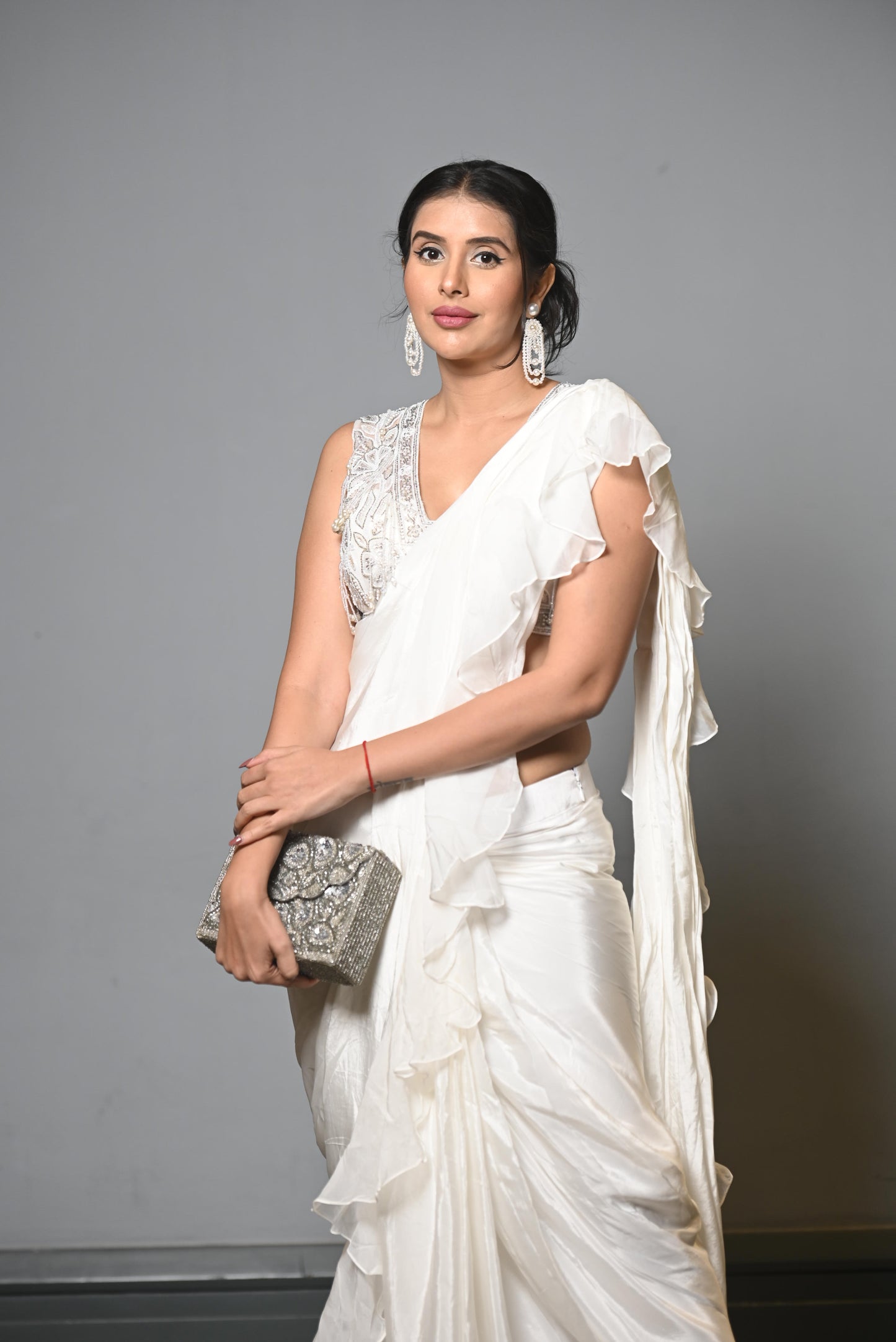 White frill, stitched sari with pearl blouse